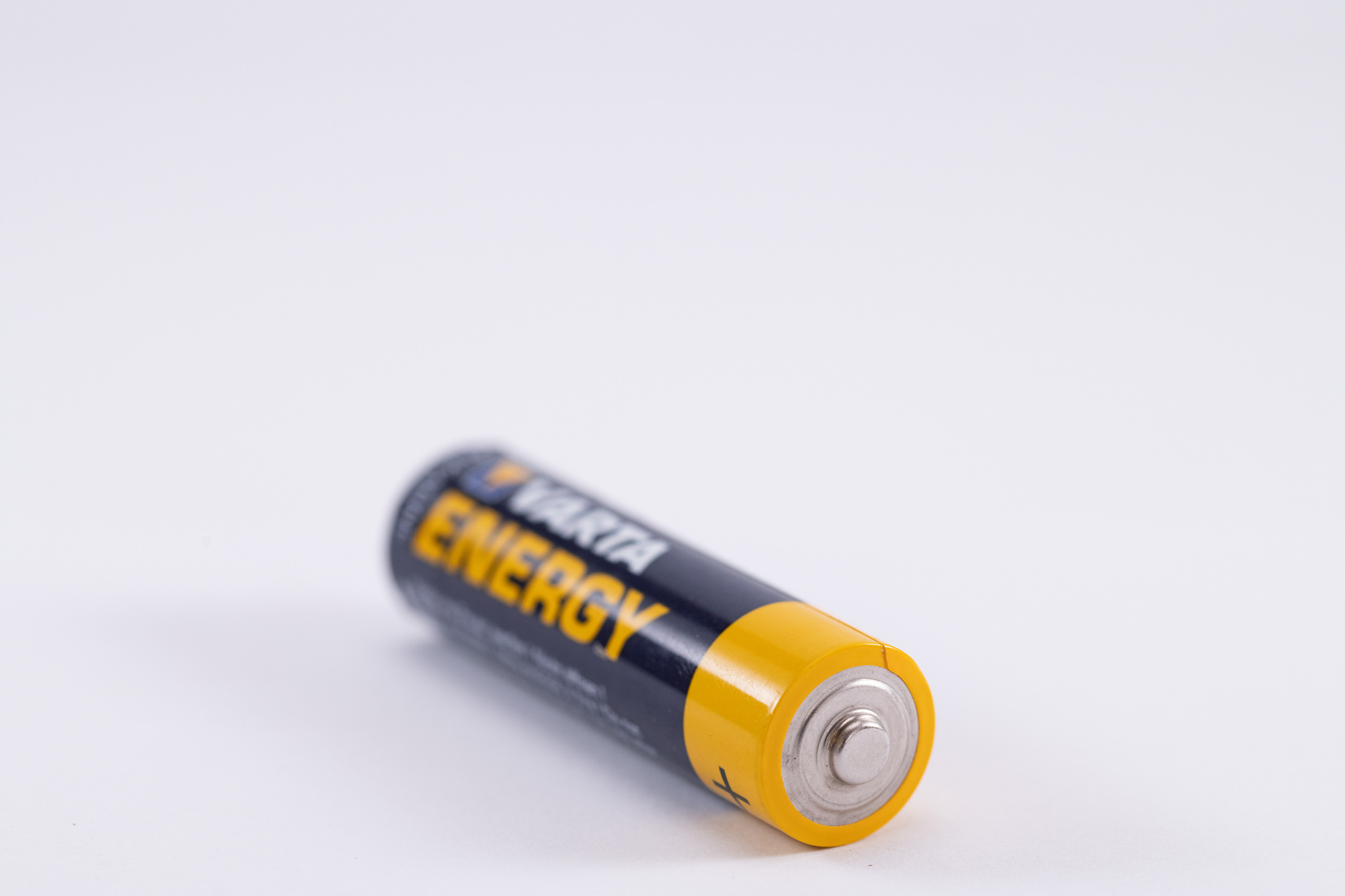 Black and Yellow Battery on White Surface